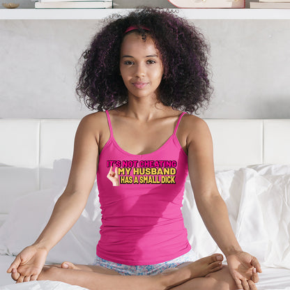 a woman in a pink tank top sitting on a bed